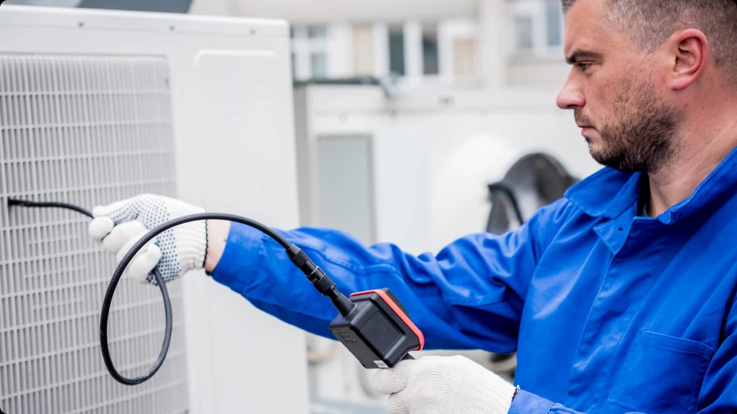 Hvac Technician Working With Ac Unit
