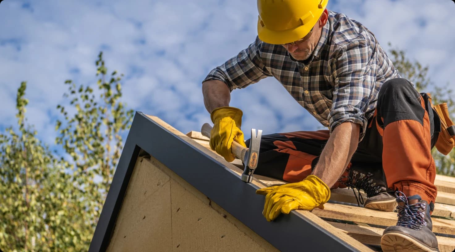 Roofer Working On House Roof