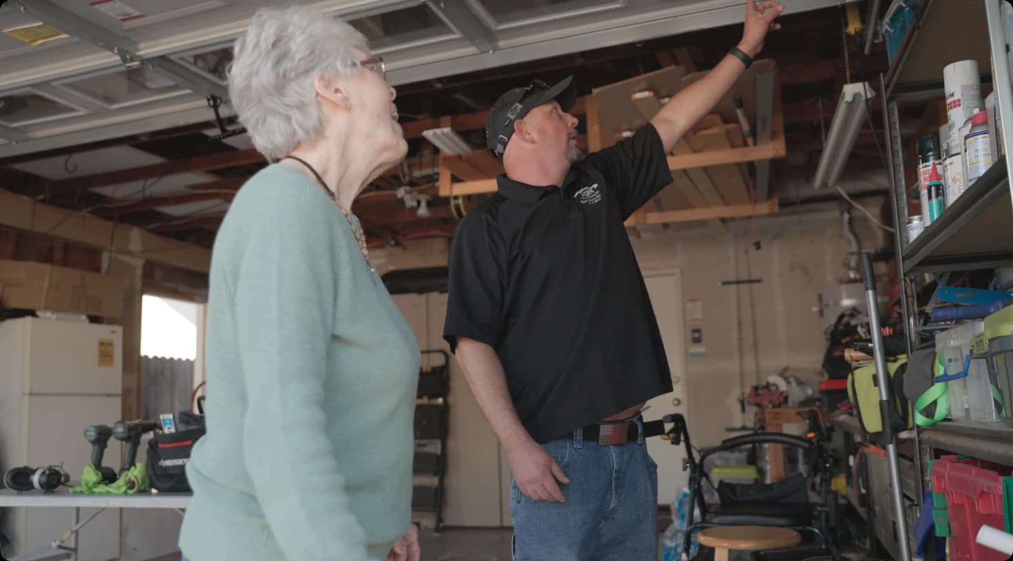 Technician Consulting Homeowner In Garage