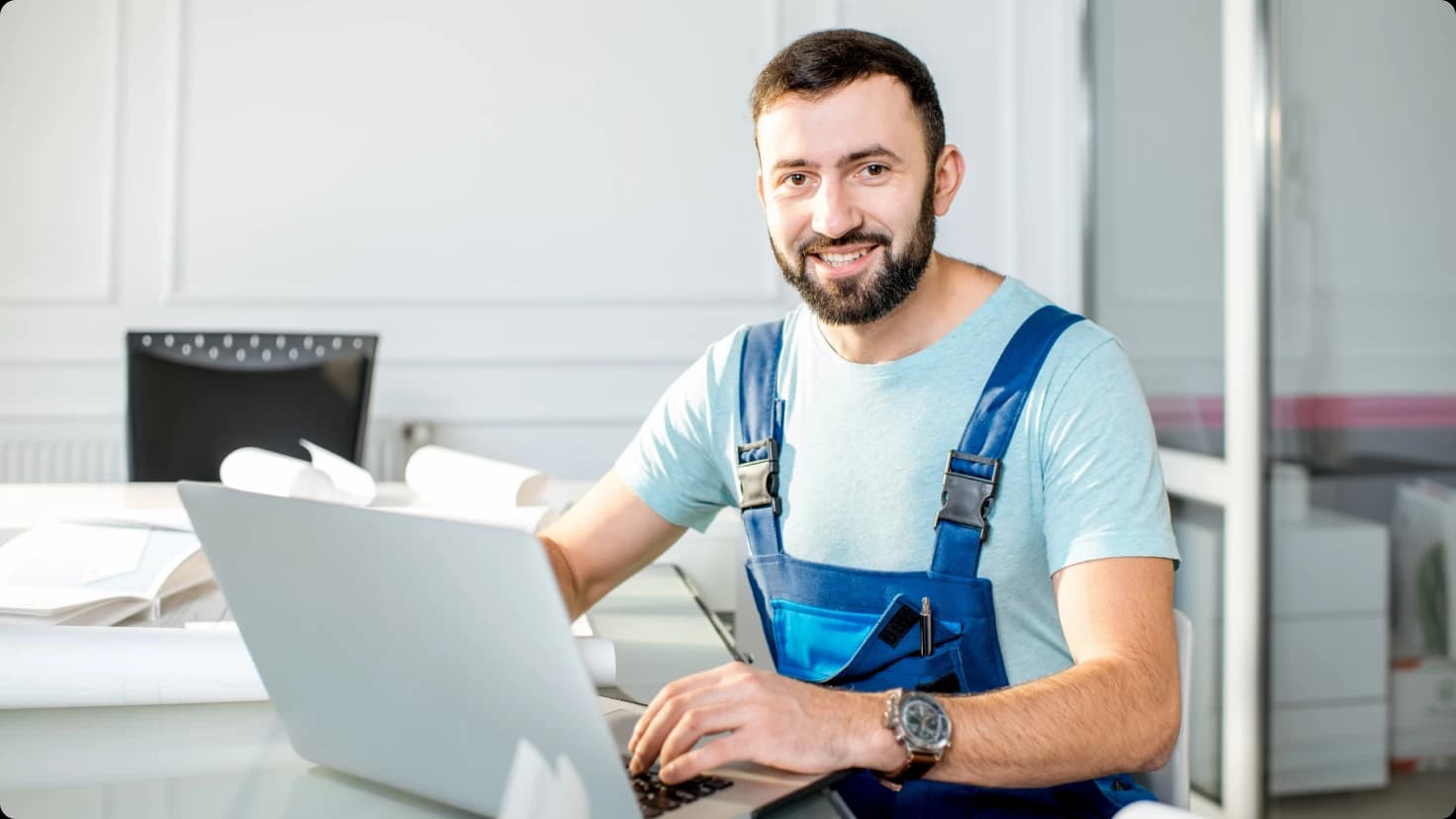 Technician Using Laptop In His Work