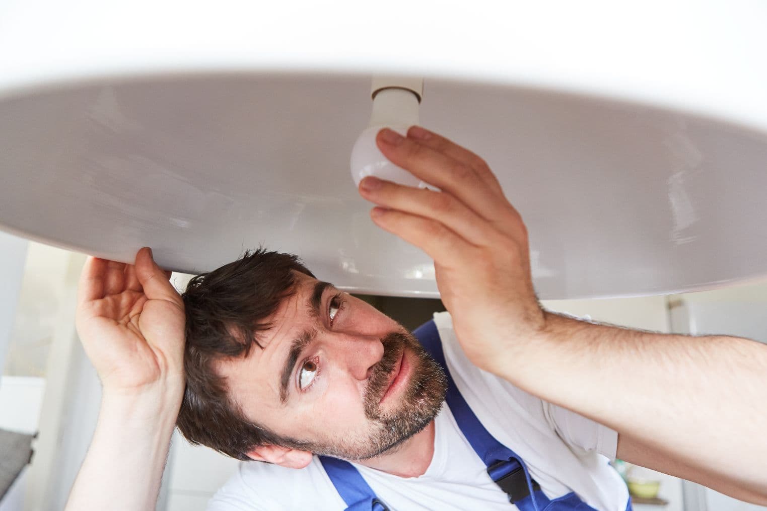 Handyman Installing A Lightbulb