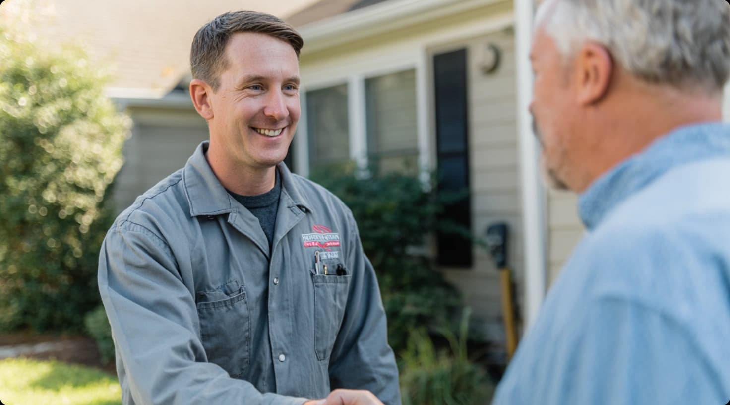 Air Duct Technician Shaking Hands With Satisfied Customer Outside Home