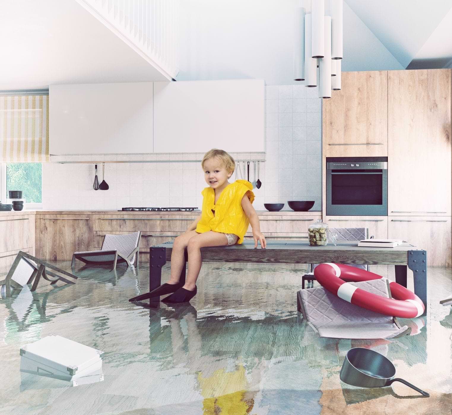 Child Sitting On A Table In A Flooded Kitchen